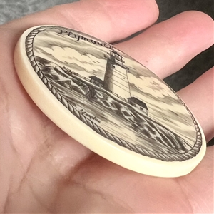 Scrimshaw on plastic of the lighthouse at Plymouth by L. Layden.