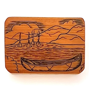 Wood studio pyrography button of a canoe and water scene.