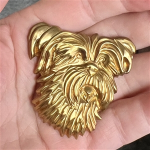 Stamped brass studio button of “Trixie by Kevin Kinne.