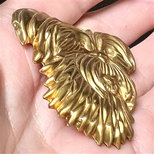 Stamped brass studio button of “Trixie by Kevin Kinne.