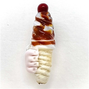 Mary Gaumonds torch-worked glass studio button of a twist ice cream cone held by a hand.