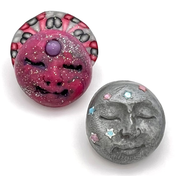 Two fimo sun and moon studio buttons.