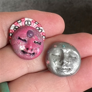 Two fimo sun and moon studio buttons.