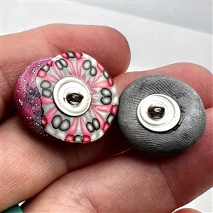 Two fimo sun and moon studio buttons.