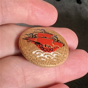 Hand painted wood button of an Asian sailing ship.