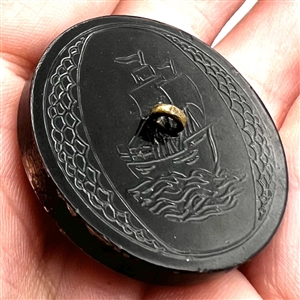 Painted acrylic button of a sailing ship.
