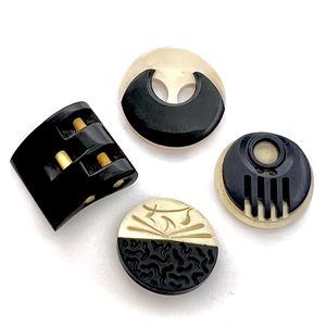 Four Vintage casein buttons in black and off white.