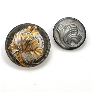 Two glass buttons of flowers.