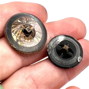 Two glass buttons of flowers.