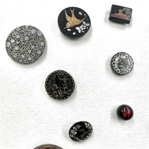 Card of 25 black glass buttons. 