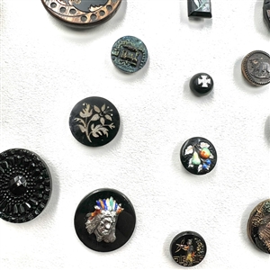 Card of 25 black glass buttons. 