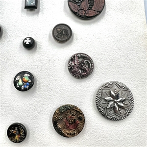 Card of 25 black glass buttons. 