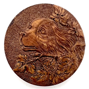 Div I  - pressed wood button of cute spaniel face in foliage. 