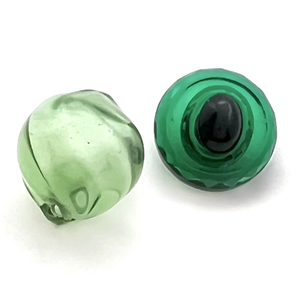 Two green glass buttons.