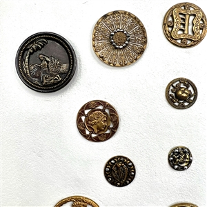Card of 20 brass buttons of assorted subjects.