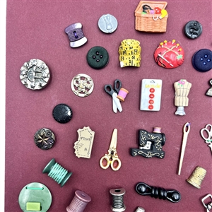 Card of 51 (mostly) sewing themed buttons .