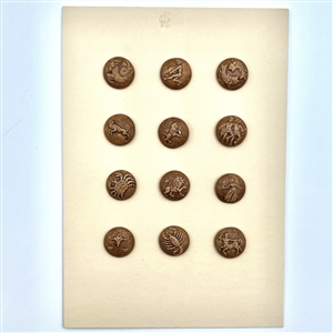 Card of 12 ceramic zodiac buttons. 