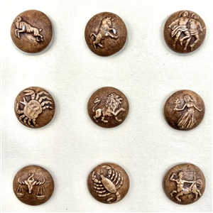 Card of 12 ceramic zodiac buttons. 