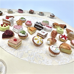 Framed card of 39 molded plastic buttons of pastries and deserts.