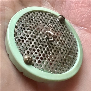 Screen back sculptural casein button with pin shank.