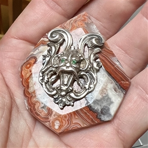 Cast silver Greenman with green paste eyes on leopardskin jasper button. 