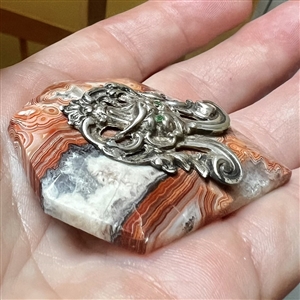 Cast silver Greenman with green paste eyes on leopardskin jasper button. 