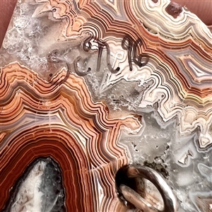 Cast silver Greenman with green paste eyes on leopardskin jasper button. 