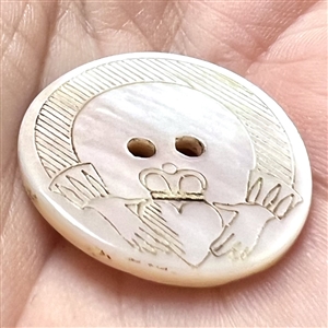 Incised and inked pearl Irish Claddagh button.