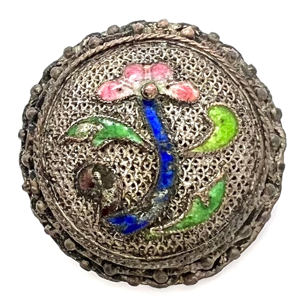 Silvered copper Asian button of an enameled flower.