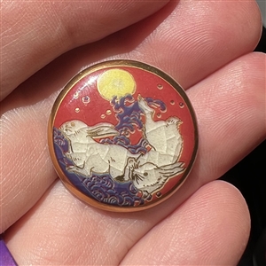 Modern Satsuma button of two rabbits under a full moon.