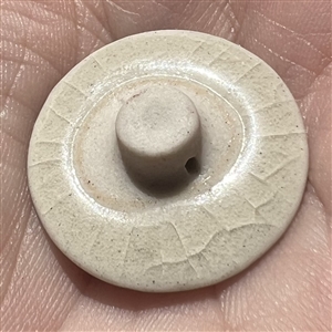 Modern Satsuma button of two rabbits under a full moon.