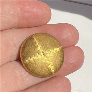 An 18th c. Death's head button on natural material.