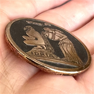 Greek Mythological aluminum button of Queen Nymph Eidyia being bathed.