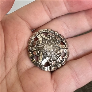 A 19th c. Silver (?) ribbons and bows  design button.