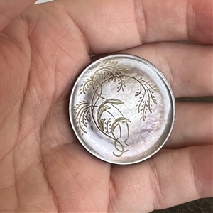 A 19th c. Incised pearl button of plant life. 