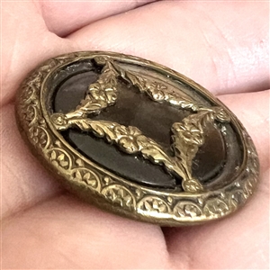 A 19th c. pearl button set metal with garland.