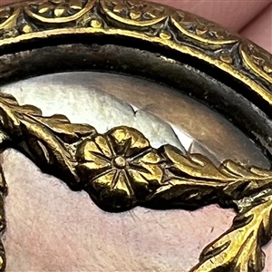 A 19th c. pearl button set metal with garland.