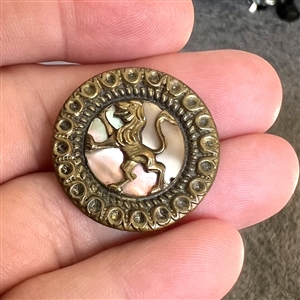 A 19th c. pearl background button in brass with rampant lion.