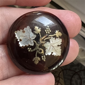 A 19th c. Tortoise button with abalone and metal inlay of grapes. 