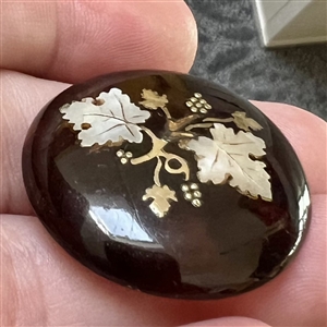 A 19th c. Tortoise button with abalone and metal inlay of grapes. 