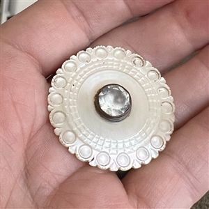 An 18th c. Carved pearl button with faceted paste center. 