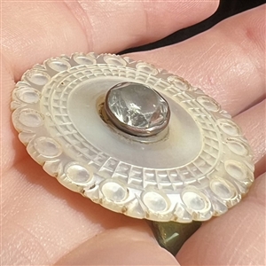 An 18th c. Carved pearl button with faceted paste center. 