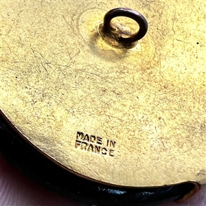 French Casein button with frosted glass profile of a woman.