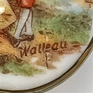 Porcelain oval button of a man and woman done in “Watteau style.
