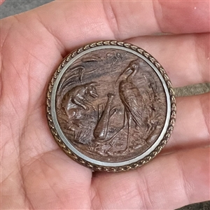 A 19th c. Fable button of fox and stork in molded wood.
