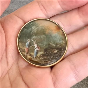 An 18th c. Painting under glass of a couple in a landscape scene.