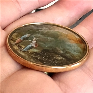 An 18th c. Painting under glass of a couple in a landscape scene.