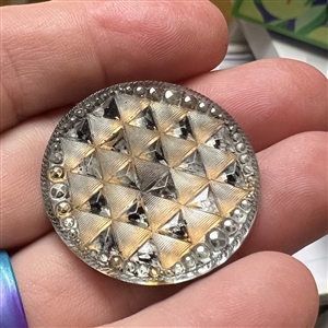 Lacy glass button of a pattern of triangles. 