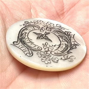 Late 19th c. Pearl button of a bird flying through a trestle.