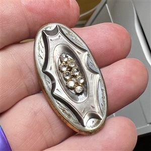 Late 19th c. Carved pearl button in metal with oval center of pastes. 